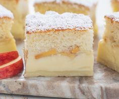 several pieces of cake sitting on top of a marble counter next to an apple slice