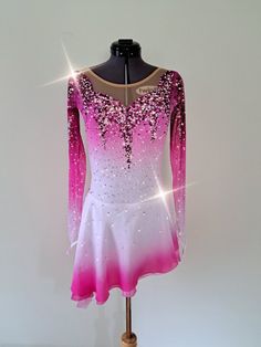 a pink and white figure skating dress on a mannequin