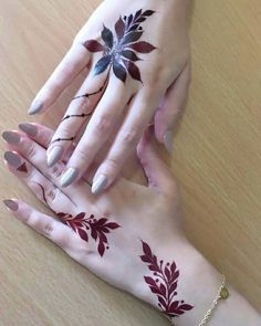 two hands with hendi designs on them