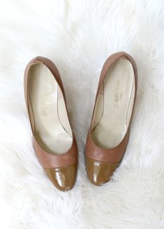 "1960's Classic pumps in women's size 6 to 6-1/2. Comfortable day heel and leather soles. Mid width heel. Patent toe cap. Genuine leather in a light brown color. In excellent vintage condition with just some light scuffing to the outers. Brand: Saks Fifth Avenue // Fenton Last Size: Labeled a size 7; Recommending a size 6 to 6-1/2. FOR REFERENCE: I wear a size 6-1/2 to 7 (9-1/8\" long feet) and these were a good tighter fit. Size is just an estimate, so please check measurements for your best fi Vintage Heels With Contrasting Heel Counter, Vintage Heels With Contrasting Heel Counter For Formal Occasions, Vintage Formal Heels With Contrasting Heel Counter, Retro Medium Width Heels For Work, Retro Fitted Heels With Leather Sole, Retro Brown Office Heels, Vintage Medium Width Heels For Work, Vintage Leather Heels With Contrasting Heel Counter, Vintage Heels With Leather Sole For Work