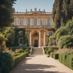 a large building with lots of trees in front of it and bushes around the entrance