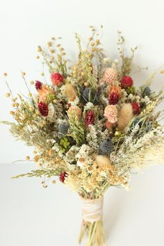 a bouquet of dried flowers on a white background