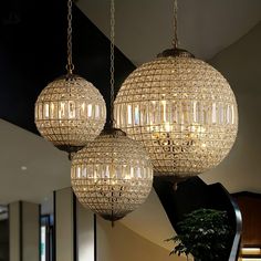 three chandeliers hanging from the ceiling in a room