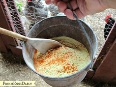 a person is stirring something in a bucket