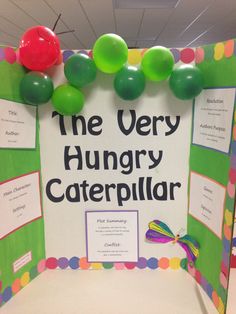 the very hungry caterpillar bulletin board is decorated with balloons and paper streamers