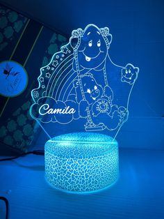 a blue illuminated lamp with an image of a woman holding a baby