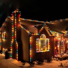 a house covered in christmas lights at night