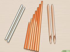 several different types of pencils sitting on top of a wooden table next to each other