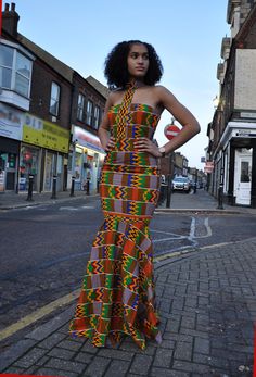 CUSTOM MADE: Our prom dresses are to be custom made in any fabric seen - tell us your size and fabric, and we will get it to you for your special day! This beautiful elegant Kente dress with fish tale front and back bottom is fully lined with back zip, which will make a statement for any special event   Body-Corn fit with flare bottom Halter neck line Back zip Sleeveless 100% Cotton Delivery will be between 2 to 3 weeks for tailor-made products! African Print Prom Dress, Flare Long Gown, Prom Dress High Neck, Prom Dress African, African Clothing Stores, Ankara Long Gown, Ghana Fashion, High Neck Prom Dress, Kente Print