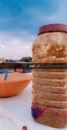 a stack of food sitting on top of a white table next to a orange bowl