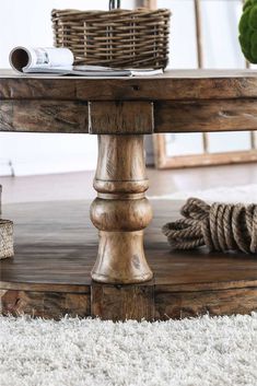 a wooden table sitting on top of a white carpeted floor next to a basket