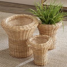 three wicker planters sitting on top of a rug