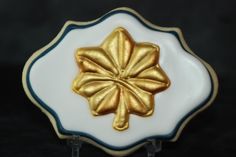 a white and blue plate with a gold flower on it