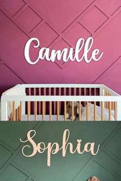 a baby crib in front of a pink wall with the name danielle on it