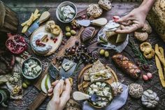 a table topped with lots of different types of cheeses and crackers on top of it