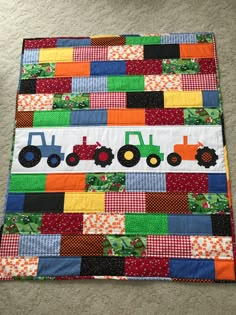 a patchwork quilt with tractors on it