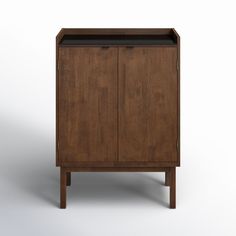 a wooden cabinet sitting on top of a white floor next to a black countertop