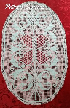 a red and white doily on a red background