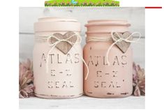 two pink mason jars sitting next to each other