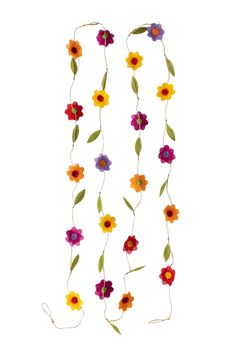 flowers are hanging from the side of a white wall