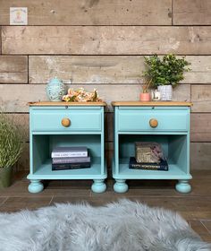 two blue nightstands with books and plants on them