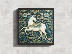 a unicorn painted on the side of a wall with flowers and leaves around it's edges