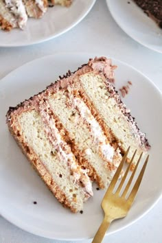 a piece of cake on a white plate with a fork in front of the slice