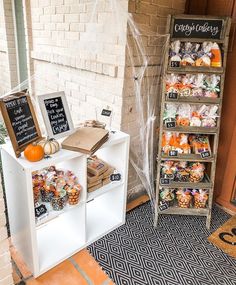 an outdoor market with pumpkins and other items for sale on the side walk way