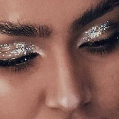 a close up of a person with glitter on their eyes