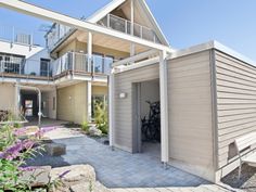 an outside view of a house with bikes parked in the driveway