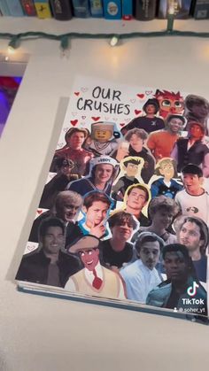 a book with pictures of people on it sitting on a table in front of bookshelves