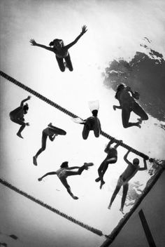 black and white photograph of people swimming in the water