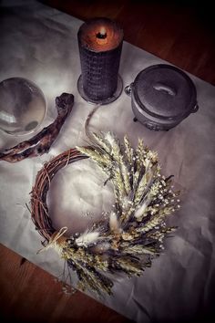 an arrangement of dried flowers and other items on a table