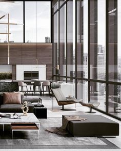 a living room filled with lots of furniture and large glass windows over looking the city