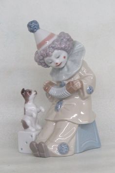 a ceramic figurine with a dog wearing a party hat