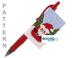 a needlepoint pen with a santa design on it