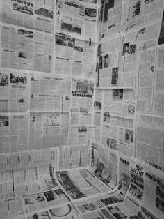 a wall covered in newspapers and papers