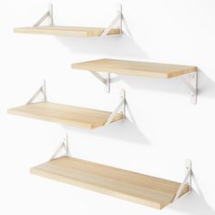 three wooden shelves with white brackets on them