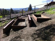 several wooden benches sitting on the side of a hill