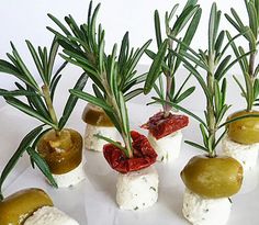 small appetizers with olives and tomatoes on them