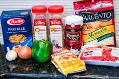 the ingredients for this meal are neatly organized on the counter top, including peppers, onions, garlic, and seasonings