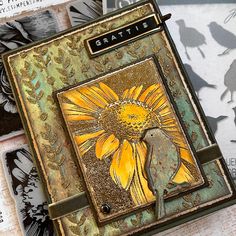 a close up of a card with flowers and birds on it, including one yellow sunflower