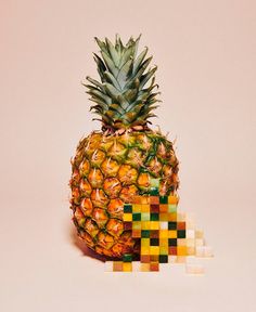 a pineapple sitting on top of a pile of diced cubes in front of it