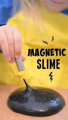 a child is playing with a magnet slime on a black rock that says, magnetic slime