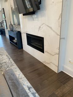 a living room with a fireplace and tv mounted on the wall