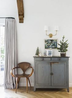 a chair sitting next to a dresser in a room