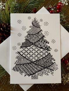 a card with a christmas tree drawn on it