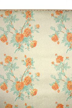 an orange and blue flowered fabric on a white background