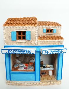 a miniature model of a bakery with blue trim