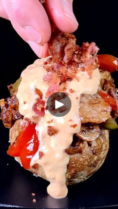 a person is dipping sauce on top of a mushroom stuffed with meat and vegetables to make a burger